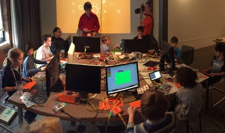 Kids making computers at a table as a team